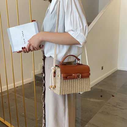 Fashion Box Rattan Women Handbags Wicker showcased on a woman holding a shopping bag in an elegant setting.