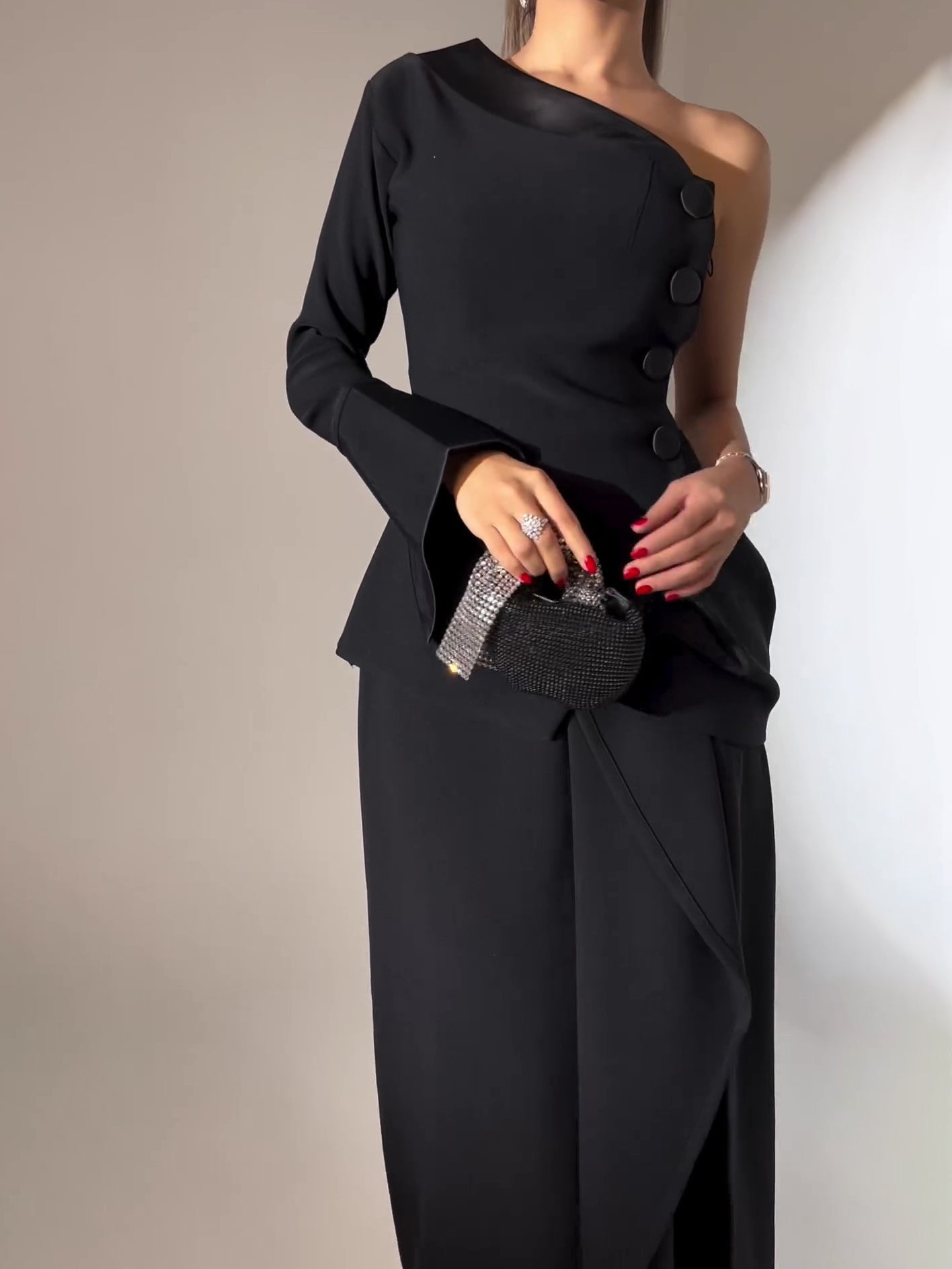 One-piece Single-breasted Top & Irregular Skirt Set featuring an elegant black design and unique button details.