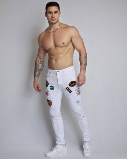 White Ripped Jeans with Badge and Black Spray Paint