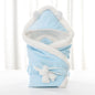 Newborn baby being hugged and swaddled by baby