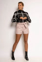 High-waisted faux leather shorts with tied belt